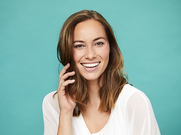 Smiling brunette in white top